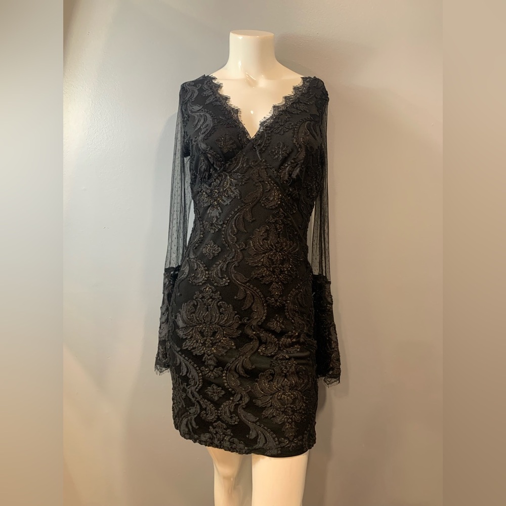 Women’s black dress with copper specks throughout.Long sleeved  
Size M
